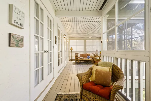 a living room with furniture a couch and a large window