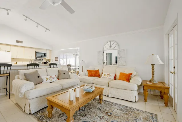 a living room with furniture and a view of kitchen