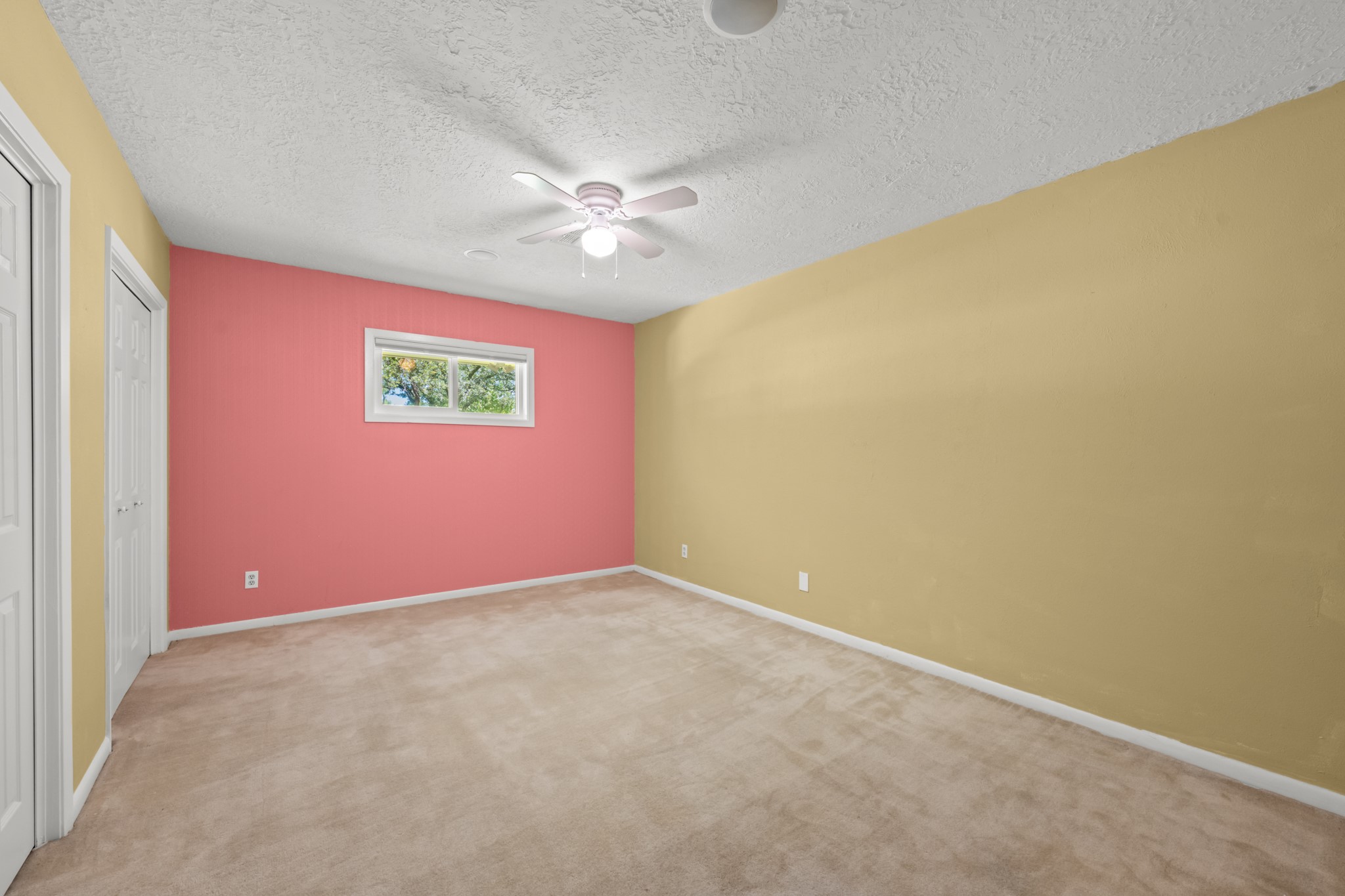 616 Cannan Drive Angleton, TX 77515 - Photo 22 of 49 This comfortable secondary bedroom features soft carpeting, a ceiling fan, and a closet for convenient storage. A window provides natural light, creating a bright and versatile space suitable for family, guests, or a home office.