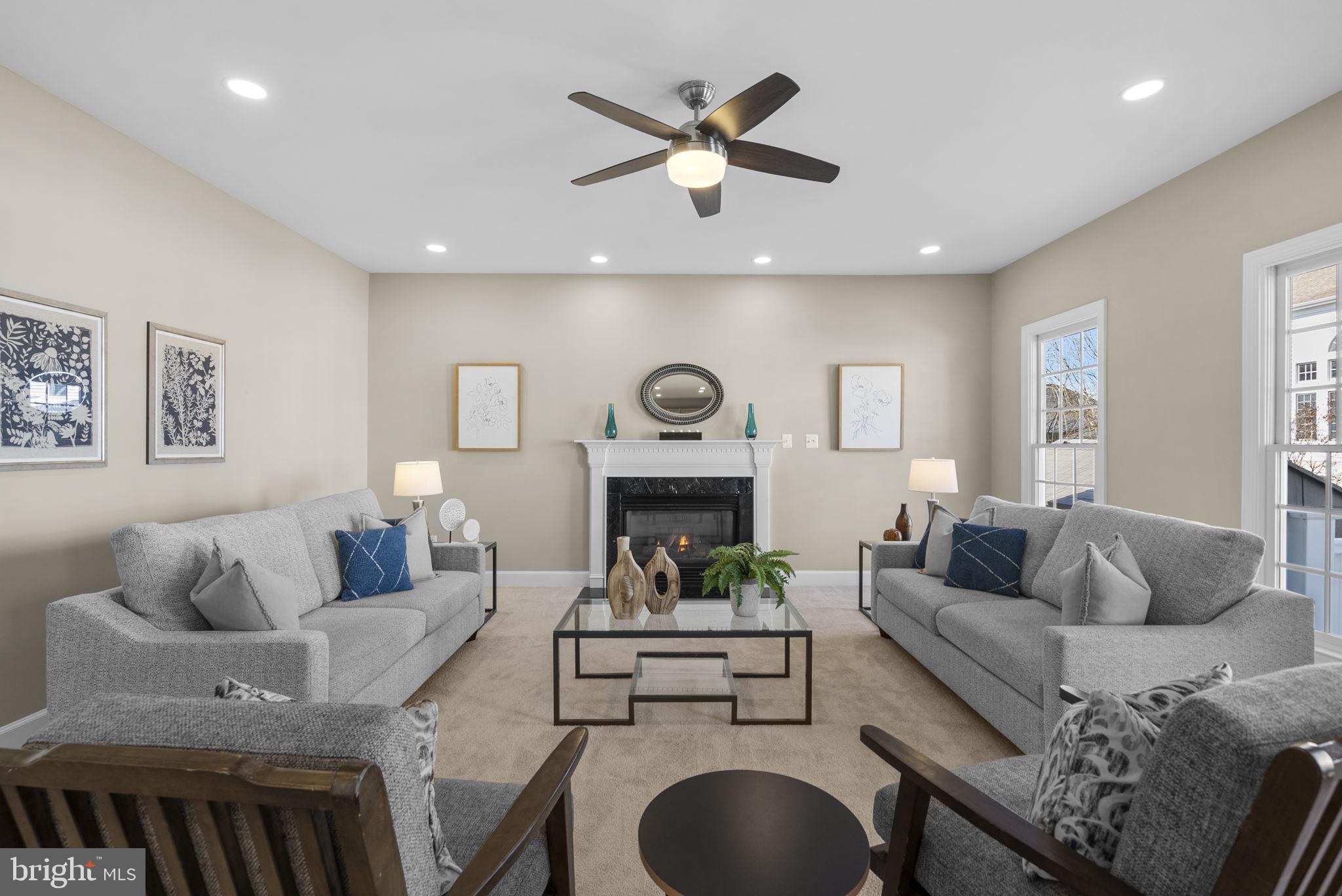 14421 Ashleigh Greene Road Boyds, MD 20841 - Photo 26 of 95 a living room with furniture a rug and a chandelier