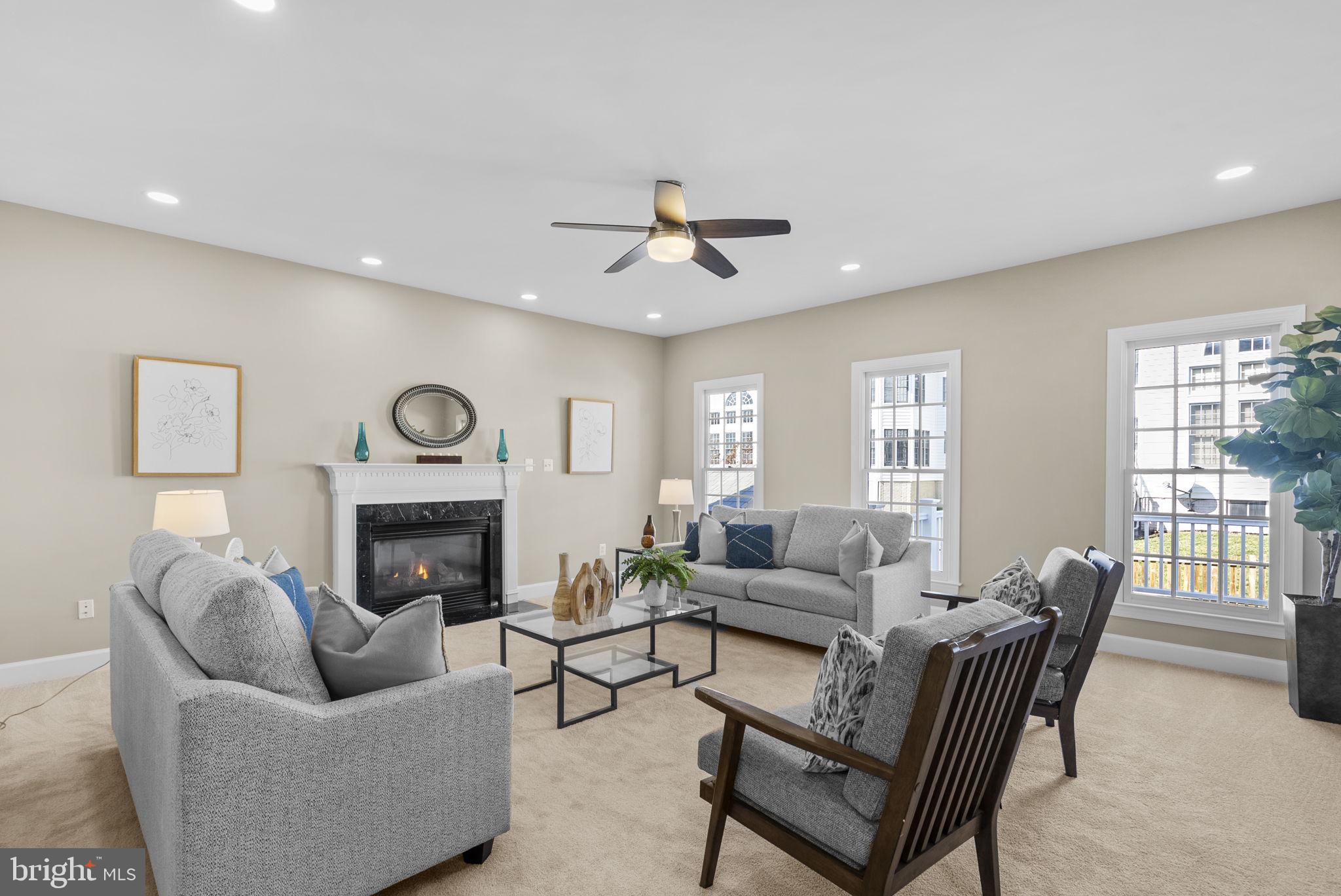 14421 Ashleigh Greene Road Boyds, MD 20841 - Photo 27 of 95 a living room with furniture and a fireplace