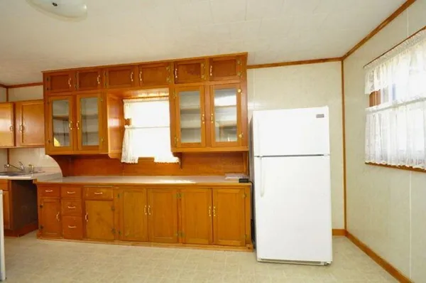 a kitchen with white cabinets and white appliances