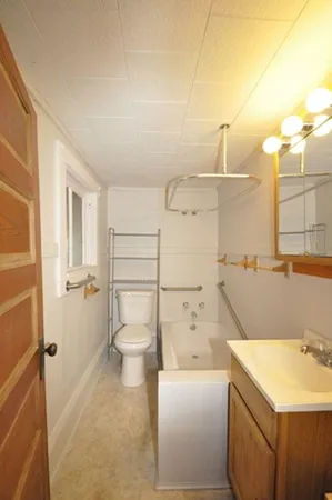 a view of a hallway with a chandelier fan