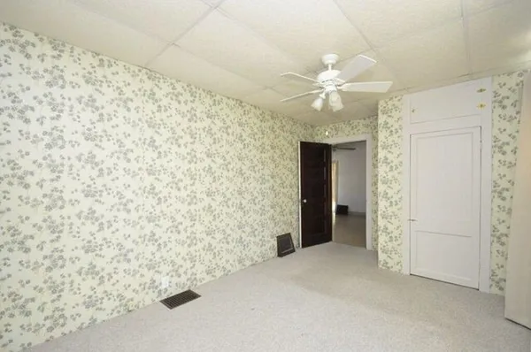 a view of an empty room with a fireplace