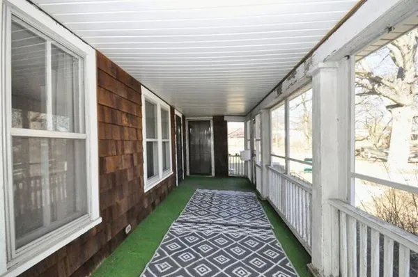a view of a porch with wooden floor and stairs