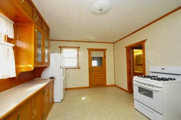 a kitchen with a refrigerator and a more cabinets