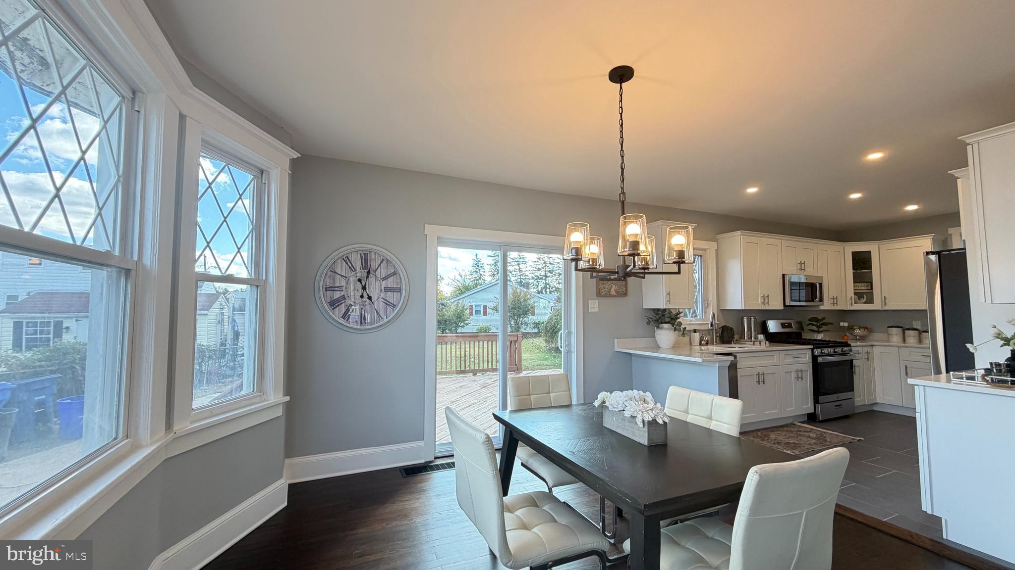718 Bordentown Road Burlington, NJ 08016 - Photo 11 of 30 a dining room with wooden floor a chandelier a wooden table and chairs