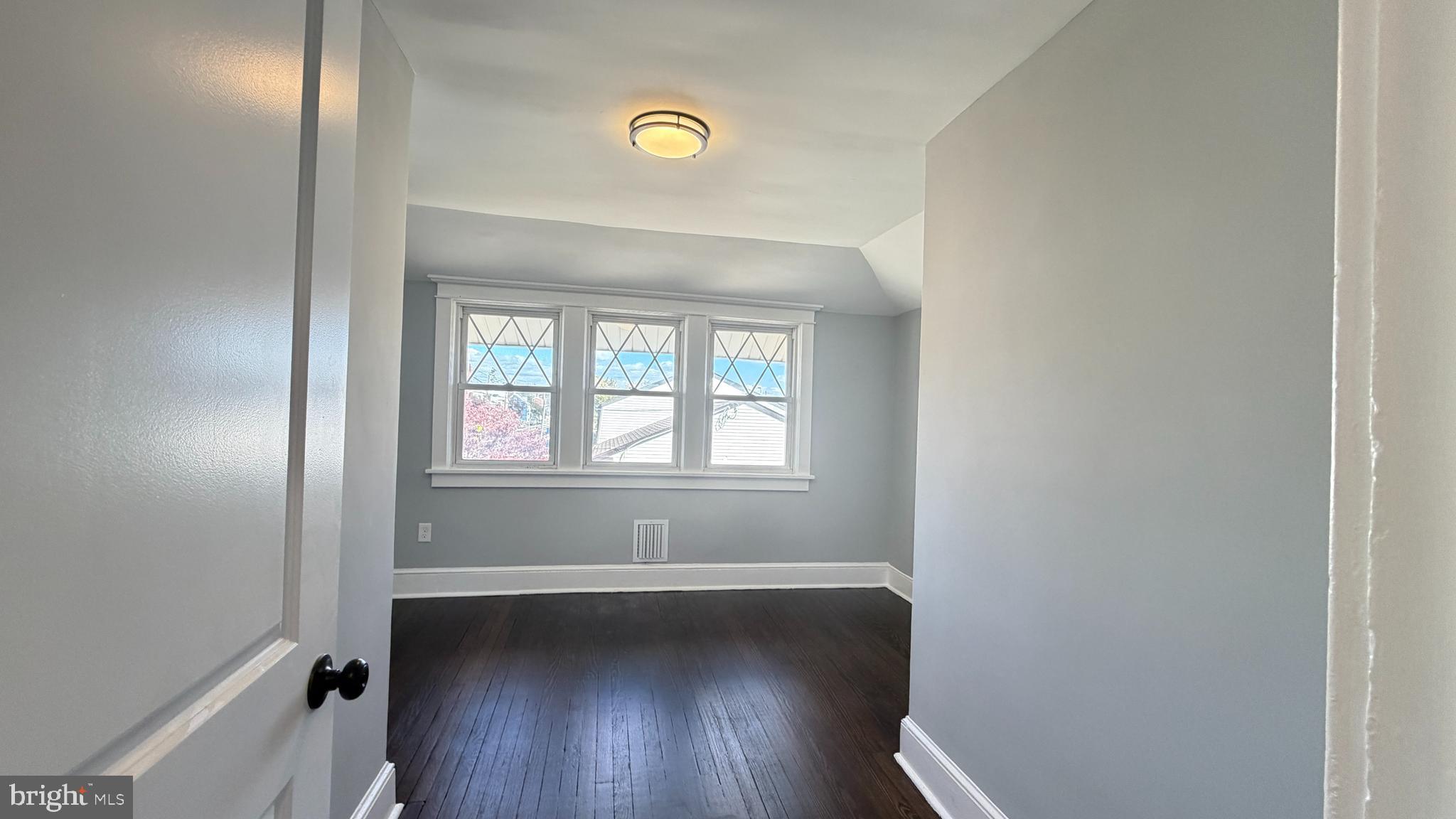 718 Bordentown Road Burlington, NJ 08016 - Photo 22 of 30 an empty room with wooden floor and windows