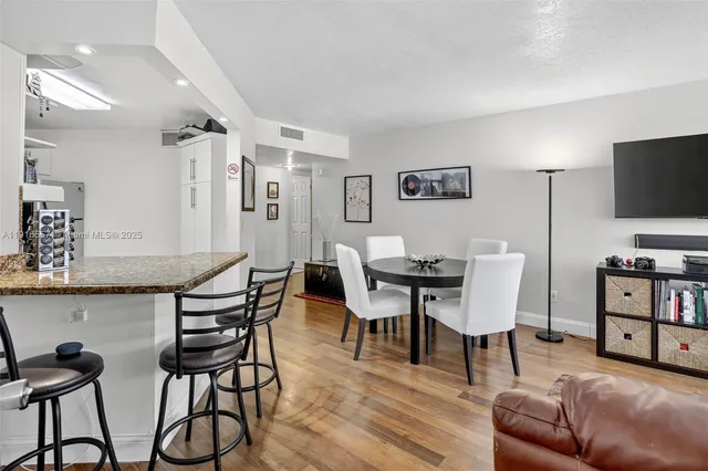 a view of a livingroom with furniture and a flat screen tv