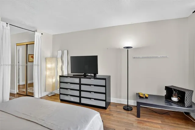 a bedroom with a bed and flat screen tv