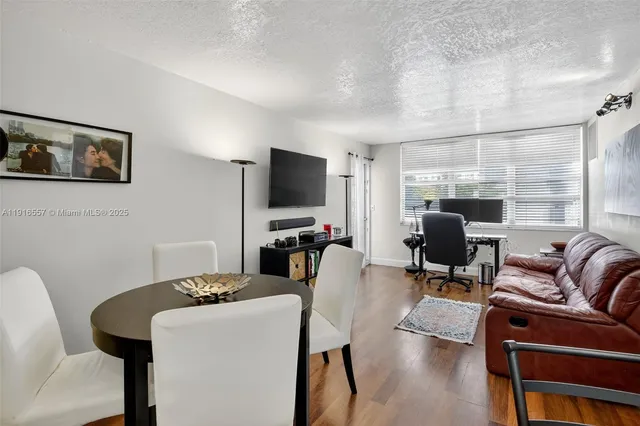 a view of a livingroom with workspace and a couch