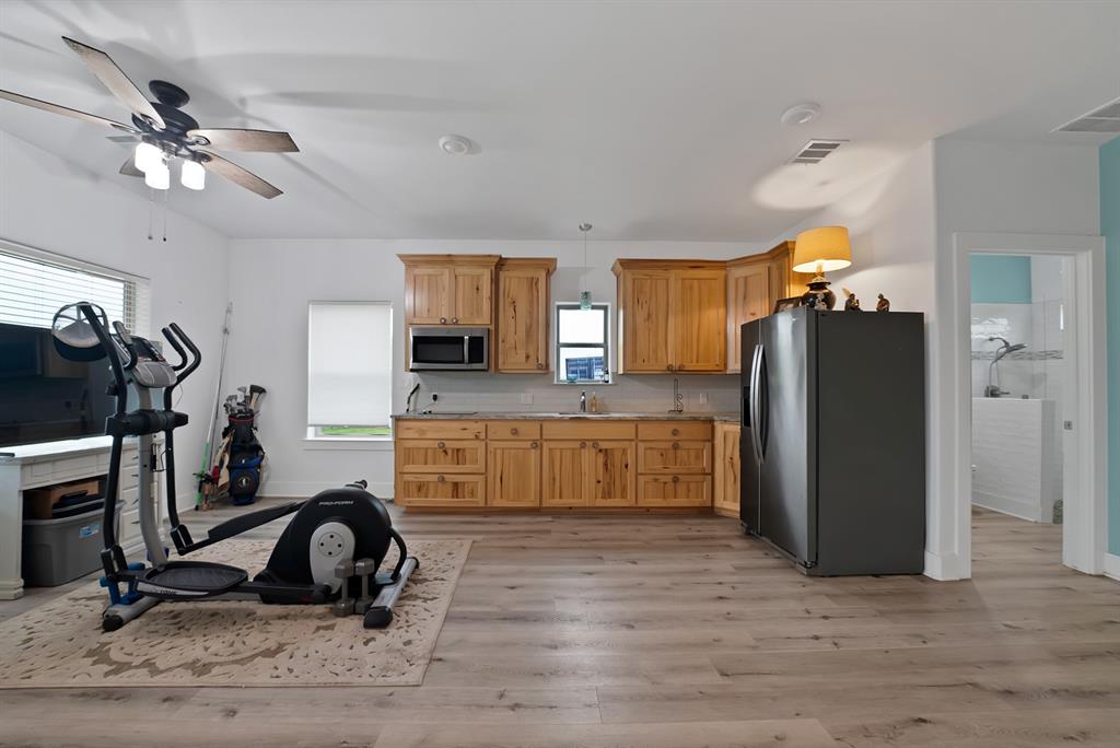 100 Shadle Ridge Court Poolville, TX 76487 - Photo 29 of 40 Open-concept room featuring light wood-finish flooring and a corner kitchenette
