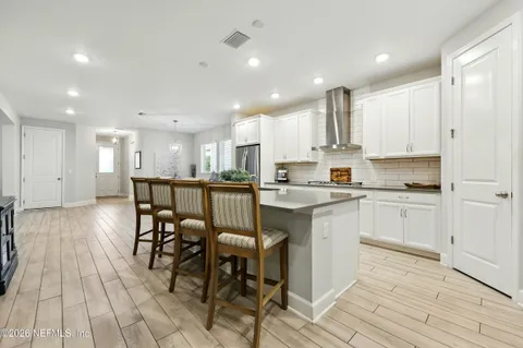 a kitchen with granite countertop a stove and cabinets