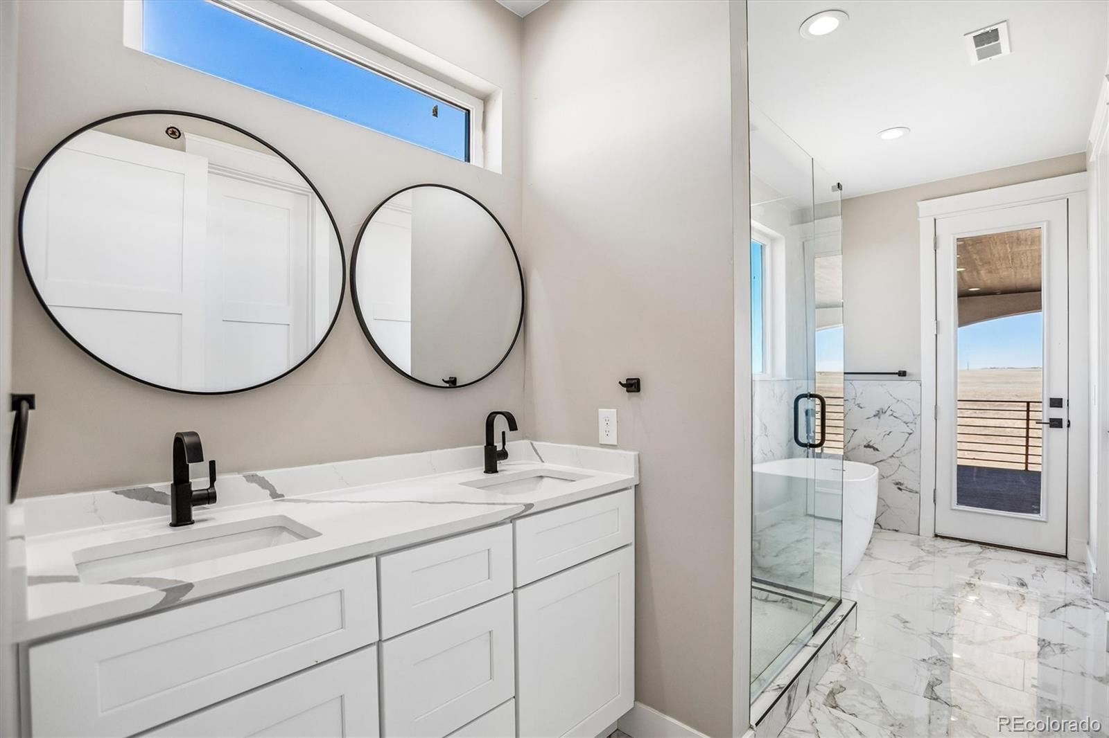 13350 Imboden Road Hudson, CO 80642 - Photo 29 of 50 a bathroom with a double vanity sink and a mirror