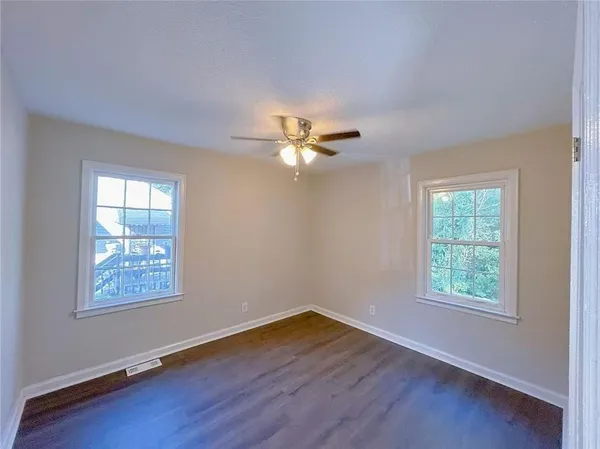 a view of wooden floor and windows in a room