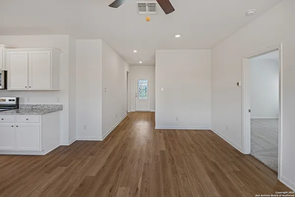 a view of a kitchen from a hallway