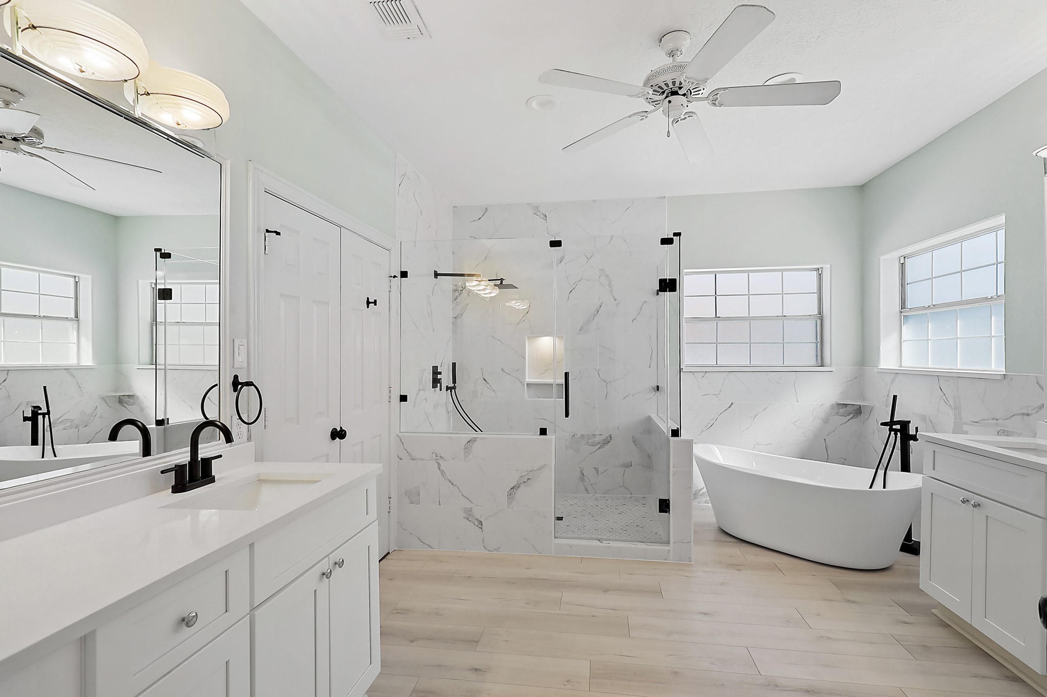 1306 Spring Branch Drive Baytown, TX 77523 - Photo 22 of 38 a spacious bathroom with a double vanity sink a mirror a shower and a bathtub