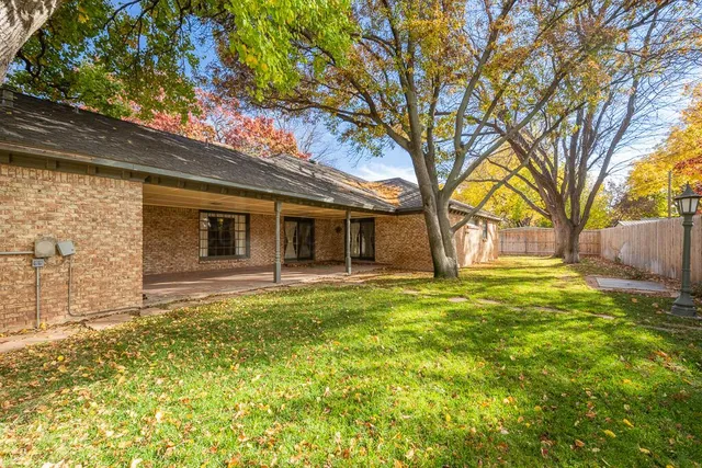 a backyard of a house with table and chairs