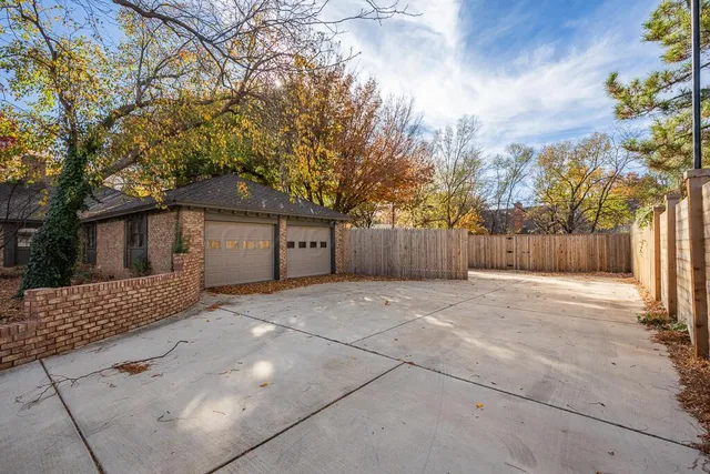 a view of a house with a backyard and trees