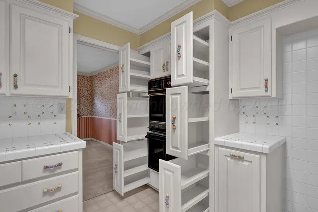 a kitchen with a refrigerator sink and cabinets