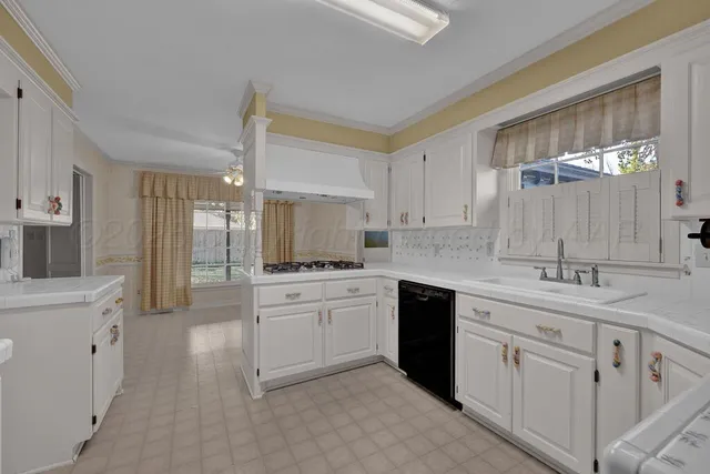 a kitchen with white cabinets and white appliances