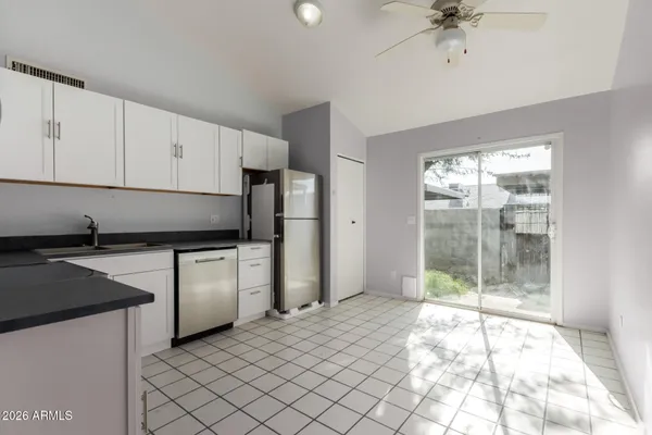 a kitchen with stainless steel appliances granite countertop a refrigerator sink and cabinets