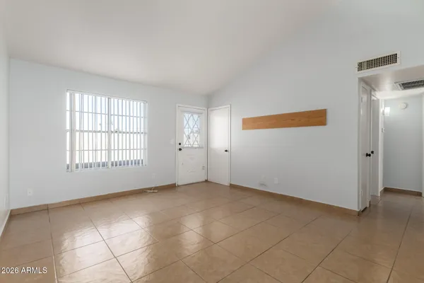 a kitchen with a sink a refrigerator and cabinets