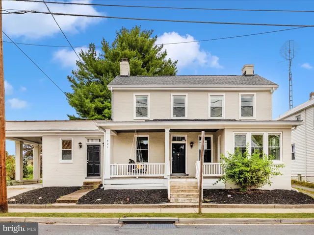 a kitchen with a sink a refrigerator and cabinets