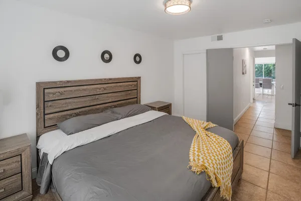 a bedroom with a bed and a chair