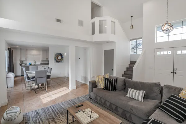 a living room with furniture and wooden floor