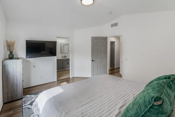 a bedroom with a bed and a flat screen tv