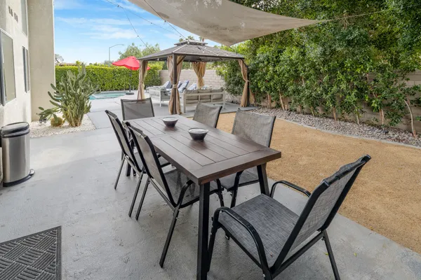 a view of a patio with a table and chairs