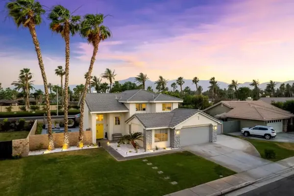 a view of a house with a yard and sitting area