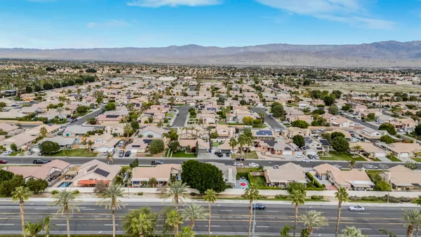 an aerial view of residential building and trees