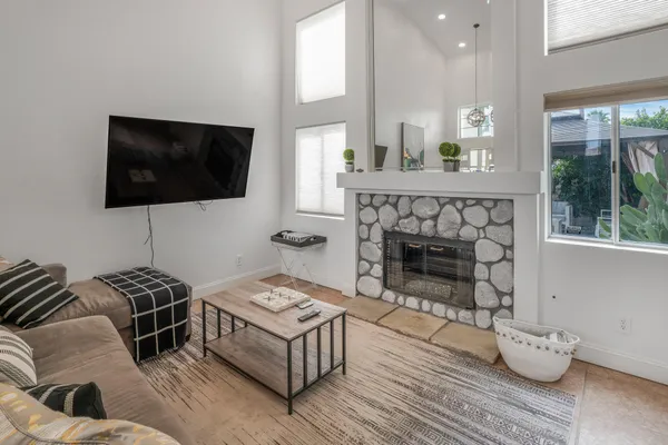 a living room with furniture a fireplace and a flat screen tv