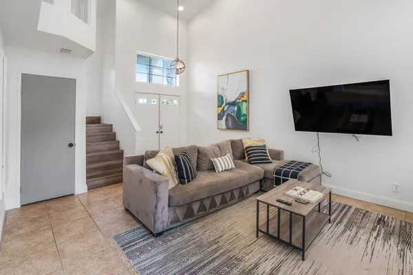 a living room with couches and a flat screen tv