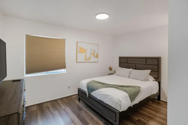 a large bed sitting in a bedroom next to a window