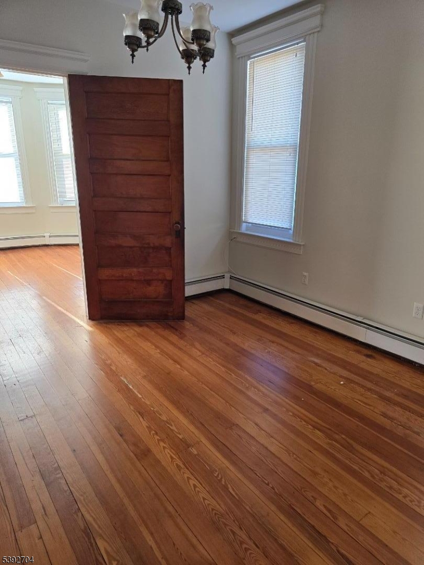 49 Barbara Street Newark, NJ 07105 - Photo 3 of 6 wooden floor and windows in a room