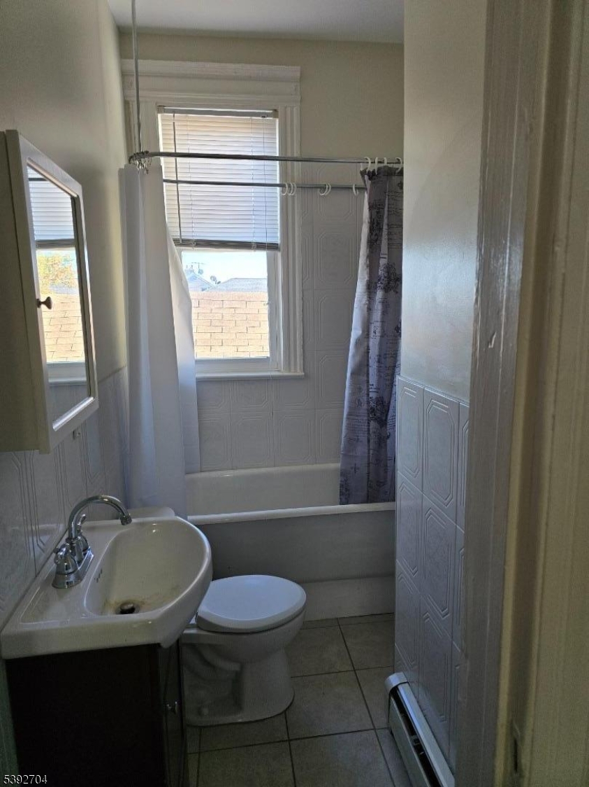 49 Barbara Street Newark, NJ 07105 - Photo 6 of 6 a bathroom with a sink toilet and shower