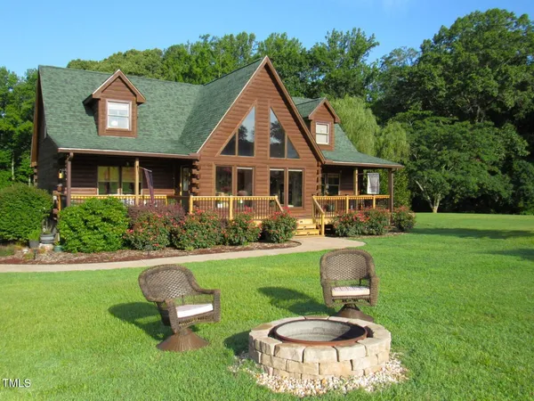 a front view of house with a garden and patio