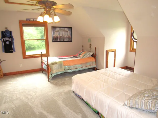 a spacious bedroom with a bed and cabinets