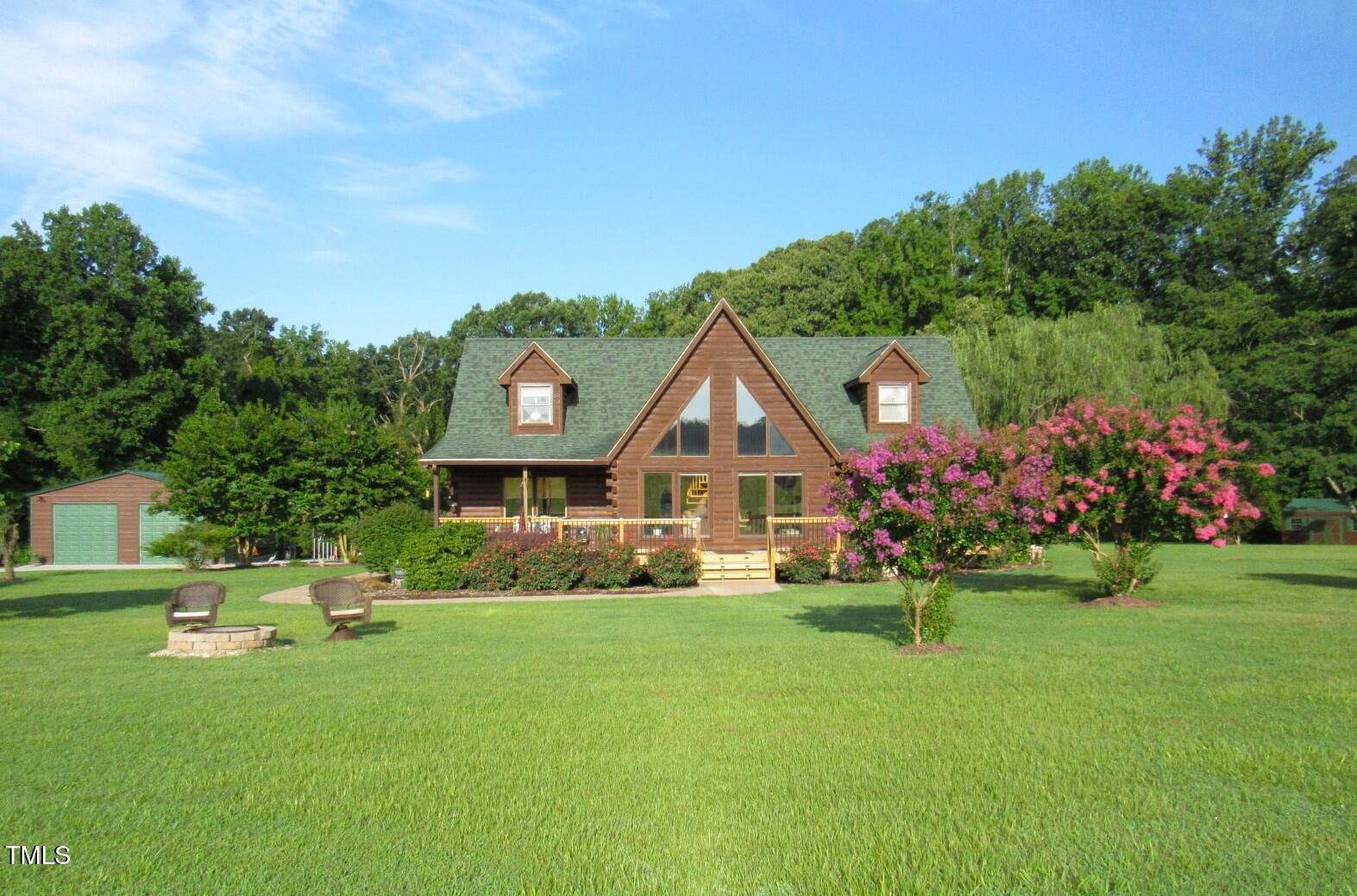 1159 Flemingtown Road Henderson, NC 27537 - Photo 3 of 51 a front view of a house with a yard