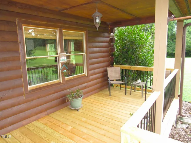 a balcony with furniture and wooden floor