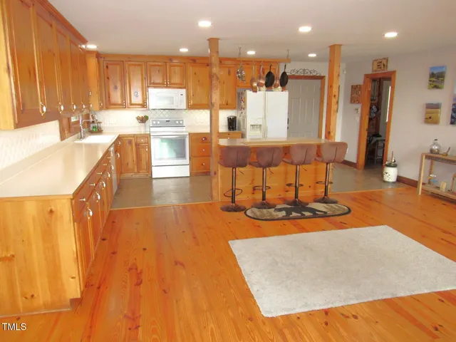 a large kitchen with stainless steel appliances lots of counter space and a sink