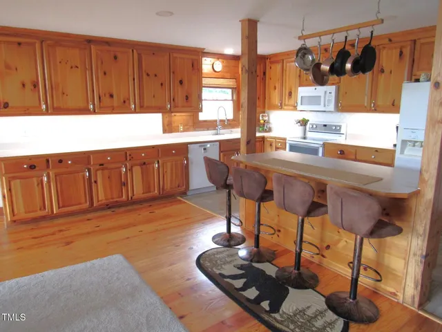 a kitchen with stainless steel appliances granite countertop a sink and a refrigerator