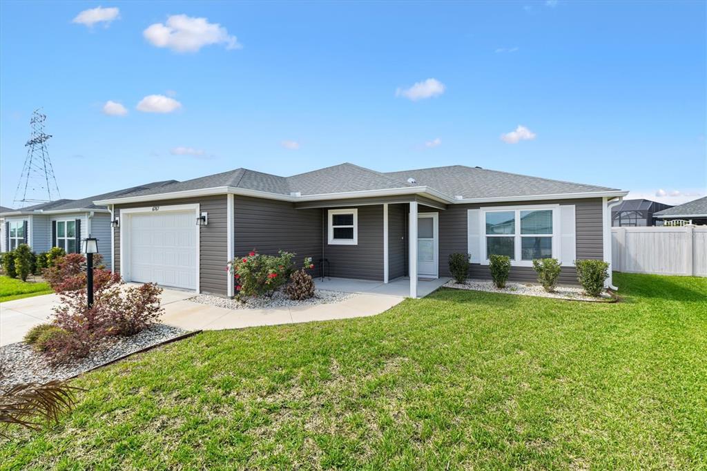 6767 Mary Loop The Villages, FL 34762 - Photo 1 of 26 a front view of house with yard and porch