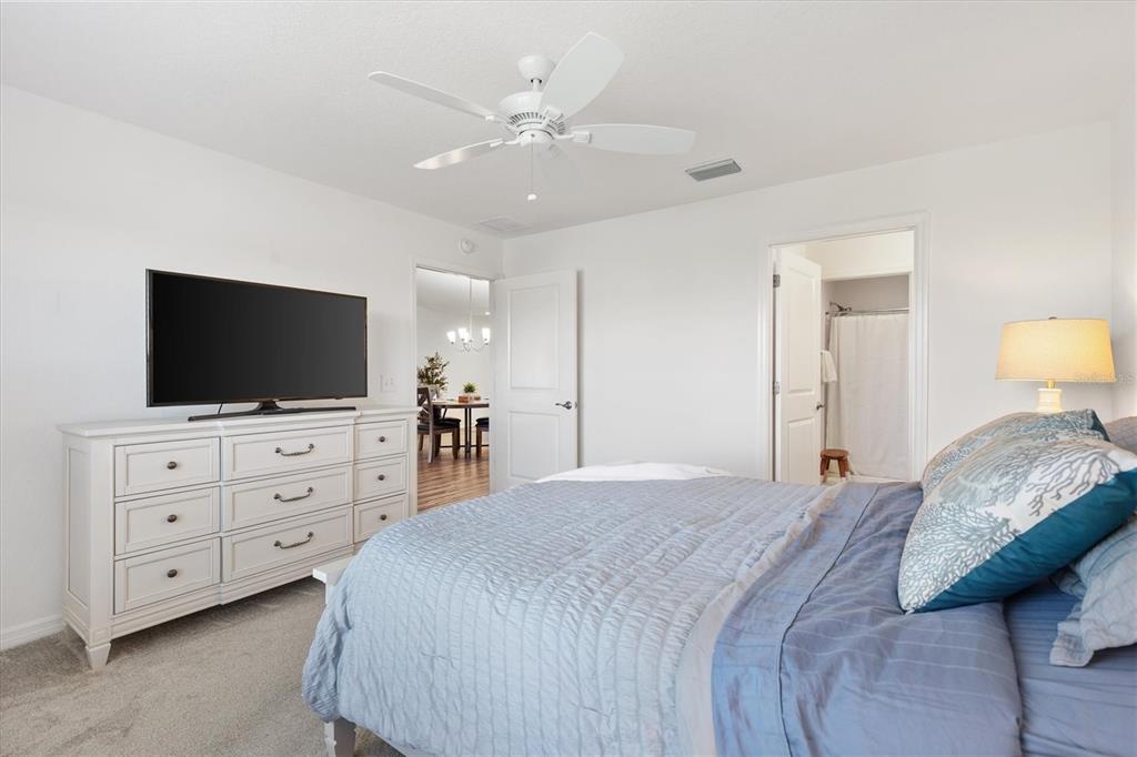 6767 Mary Loop The Villages, FL 34762 - Photo 11 of 26 a bedroom with a large bed and a flat screen tv