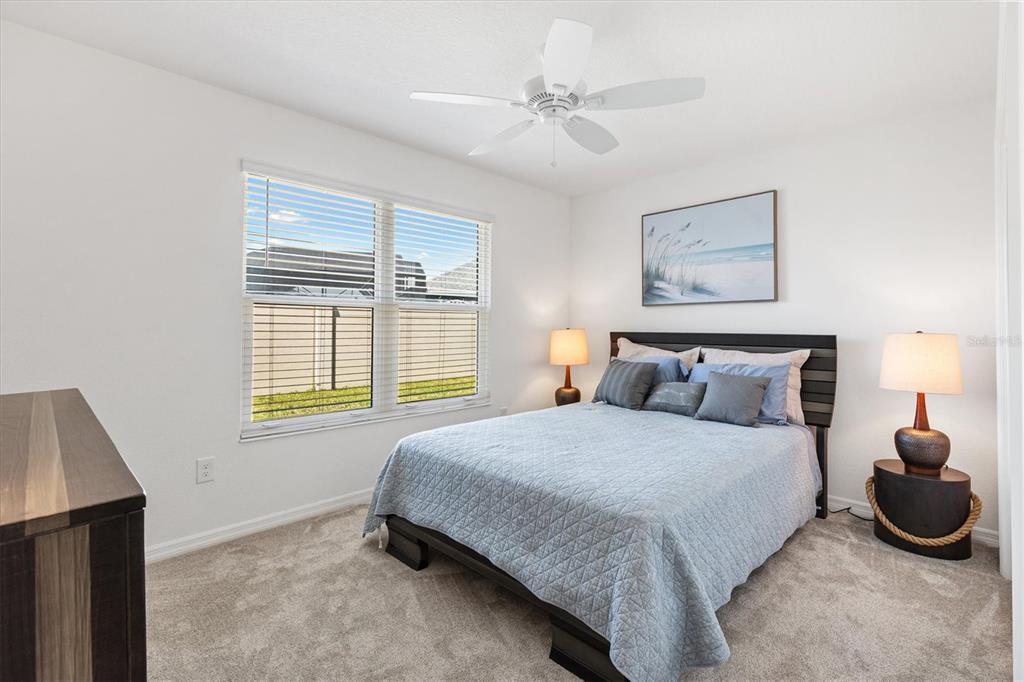 6767 Mary Loop The Villages, FL 34762 - Photo 13 of 26 a bedroom with a bed and a window