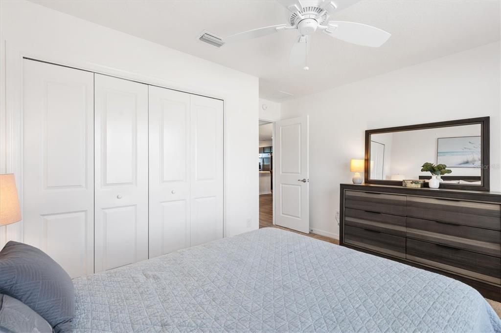 6767 Mary Loop The Villages, FL 34762 - Photo 14 of 26 a room with a bed and a chandelier