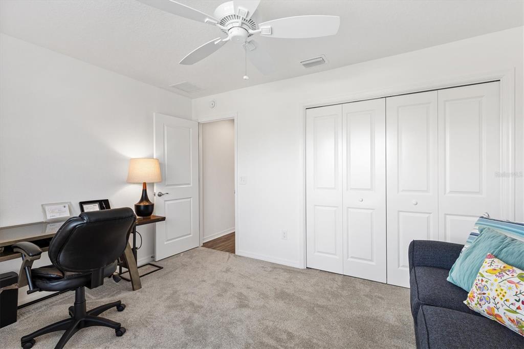 6767 Mary Loop The Villages, FL 34762 - Photo 17 of 26 a view of a workspace with furniture and a ceiling fan